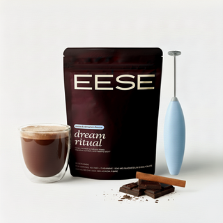 Eese dream ritual coffee package with a glass of coffee, chocolate, and a milk frother on a white background